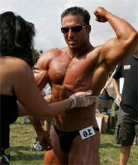 bodybuilder being oiled before competition Bodybuilder being oiled before competition.