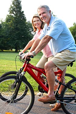 Older couple riding bike