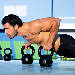 man using kettlebells