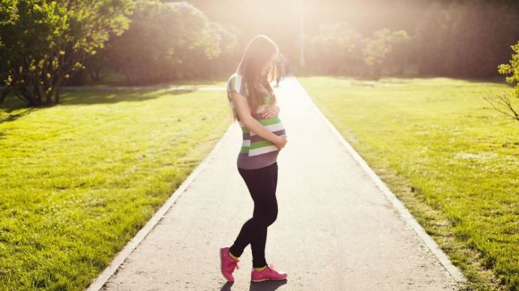 pregnant woman walking outdoors