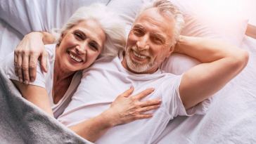 happy senior couple in bed