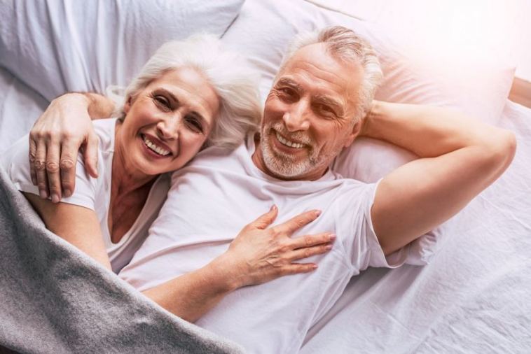 happy senior couple in bed