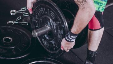man lifting weights