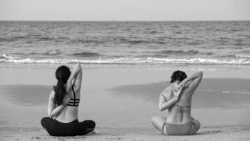 women stretching on beach