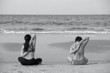women stretching on beach