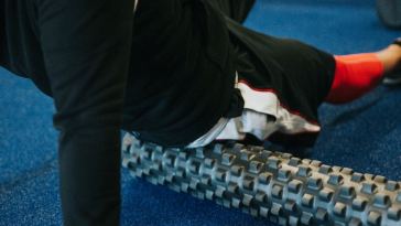 man foam rolling