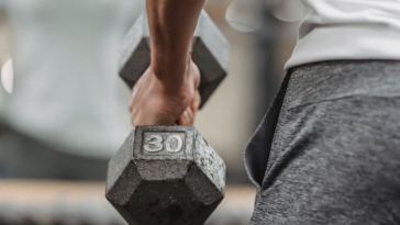 man lifting dumbbell