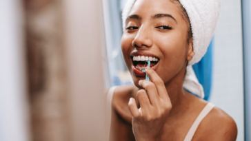girl flossing teeth