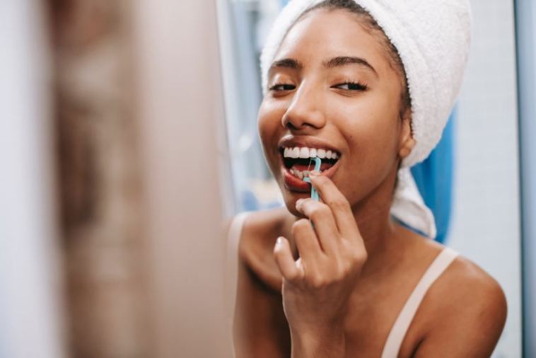 girl flossing teeth
