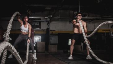 man and woman battling ropes