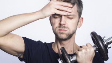 man lifting dumbell