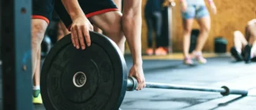 man lifting weights